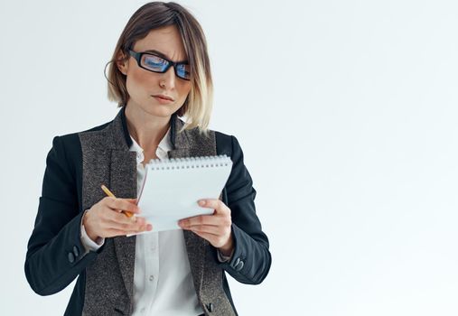 Woman in a suit with documents on a light background cropped view of a jacket with a shirt. High quality photo