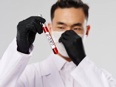 Male laboratory technicians black gloves research medical mask blood test. High quality photo