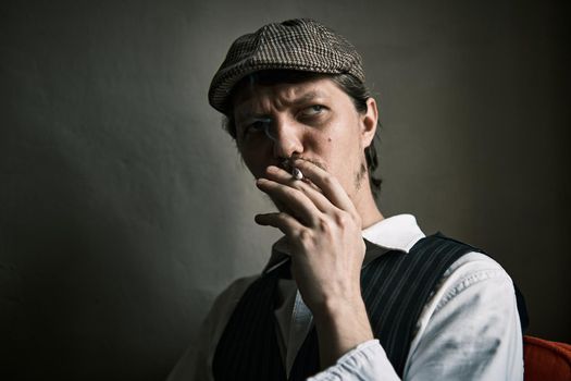 Young guy smoke cigarette, blows smoke, dressed in a retro style, in a beret, cinematic shot, big closeup