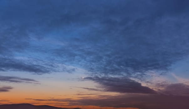 Evening sky with clouds and moon