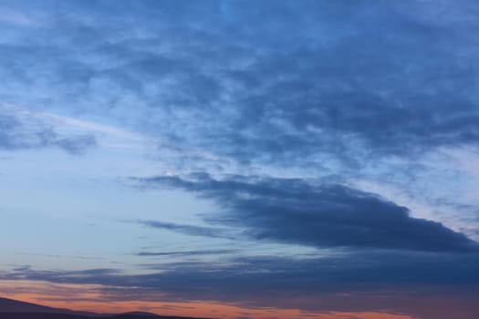 Evening sky with clouds and moon
