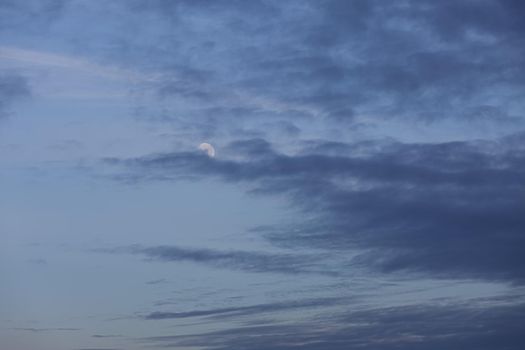 Evening sky with clouds and moon