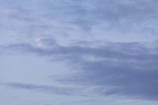 Evening sky with clouds and moon