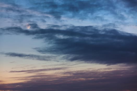 Evening sky with clouds and moon