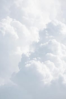 Sky with clouds, a view from an aeroplane above the clouds. Abstract nature background with clouds in light tonality. White cumulus clouds
