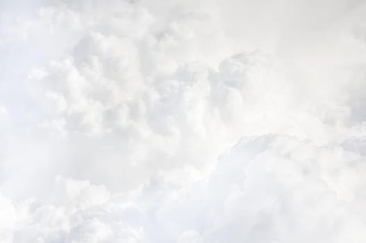 Sky with clouds, a view from an aeroplane above the clouds. Abstract nature background with clouds in light tonality. White cumulus clouds