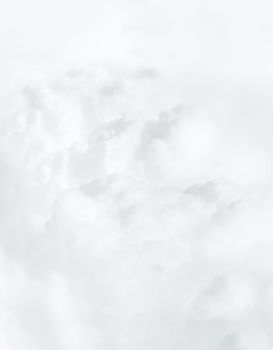 Sky with clouds, a view from an aeroplane above the clouds. Abstract nature background with clouds in light tonality. White cumulus clouds