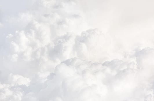 Sky with clouds, a view from an aeroplane above the clouds. Abstract nature background with clouds in light tonality. White cumulus clouds