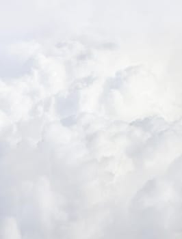 Sky with clouds, a view from an aeroplane above the clouds. Abstract nature background with clouds in light tonality. White cumulus clouds