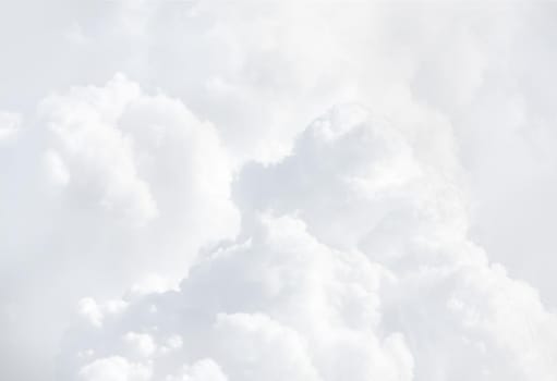 Sky with clouds, a view from an aeroplane above the clouds. Abstract nature background with clouds in light tonality. White cumulus clouds