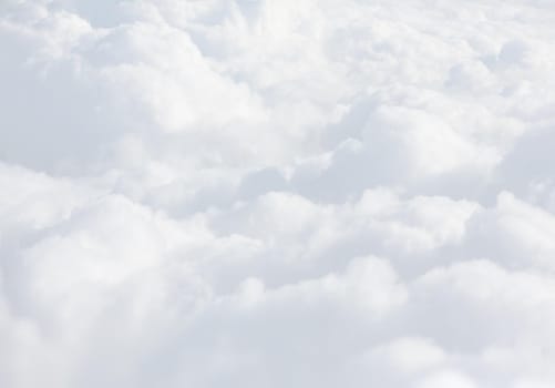Sky with clouds, a view from an aeroplane above the clouds. Abstract nature background with clouds in light tonality. White cumulus clouds