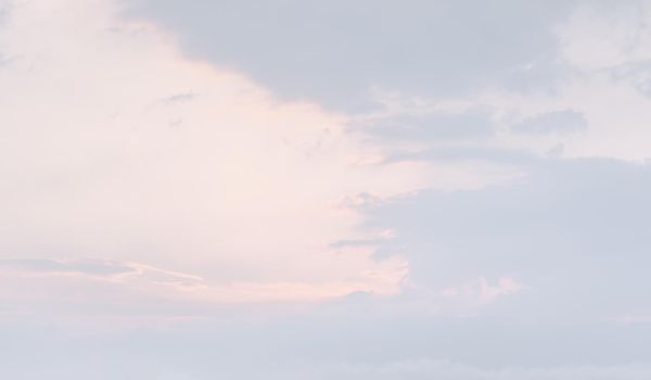 Natural sky background with clouds in light tonality. Abstract nature image for background use.