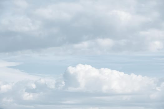 Natural sky background with clouds in light tonality. Abstract nature image for background use.