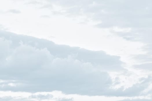 Natural sky background with clouds in light tonality. Abstract nature image for background use.