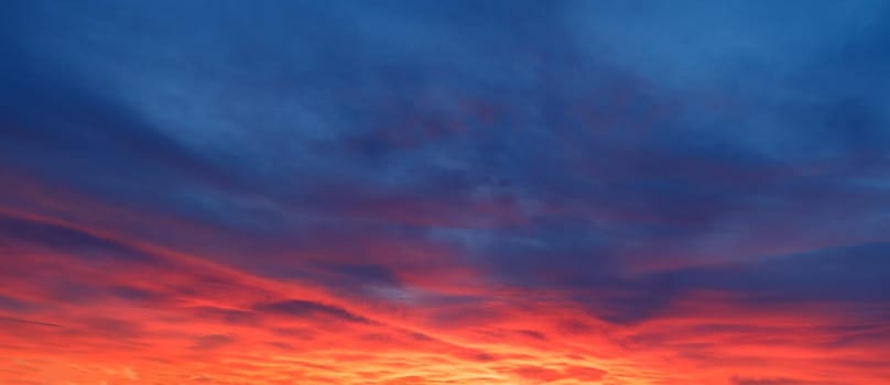 Fiery orange and blue sunset sky. Dramatic sunset and sunrise sky.