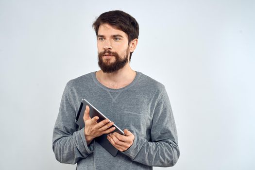 A bearded man with a tablet in the hands of a wireless communication technology device. High quality photo