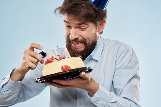 Bearded man with cap on his head cake holiday gift emotions. High quality photo