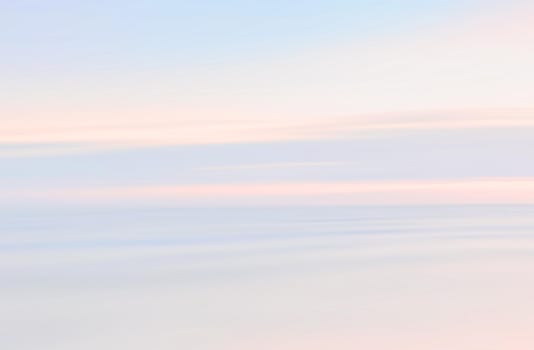 Abstract blurred sea landscape and cloudy sky background in light tonality with copy space