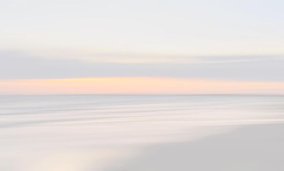 Abstract blurred sea landscape and cloudy sky background in light tonality with copy space