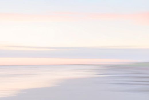 Abstract blurred sea landscape and cloudy sky background in light tonality with copy space