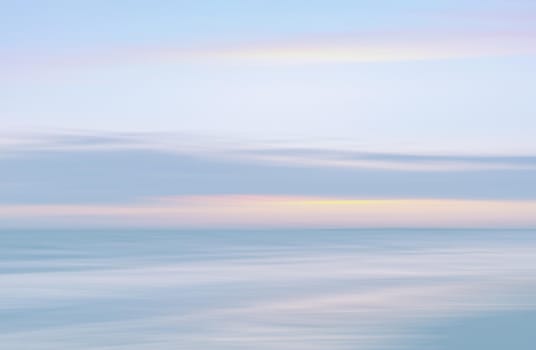 Abstract blurred sea landscape and cloudy sky background in light tonality with copy space