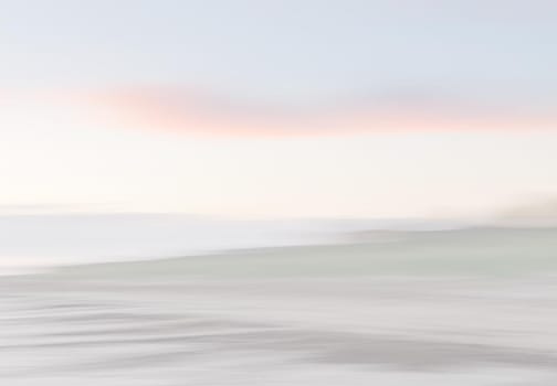 Abstract blurred sea landscape and cloudy sky background in light tonality with copy space