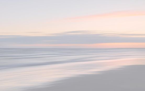 Abstract blurred sea landscape and cloudy sky background in light tonality with copy space