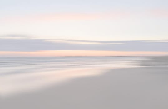 Abstract blurred sea landscape and cloudy sky background in light tonality with copy space
