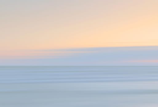 Abstract blurred sea landscape and cloudy sky background in light tonality with copy space