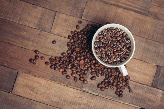 cup with coffee grains on a wooden table aromatic drink. High quality photo