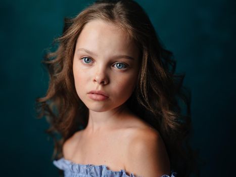 Portrait of a beautiful girl with curly hair hairstyle model bared shoulders. High quality photo