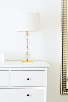 Lamp with gold and crystal design in white interior, luxury home decor concept