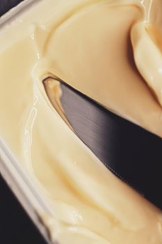 Soft spread butter and knife, breakfast food closeup