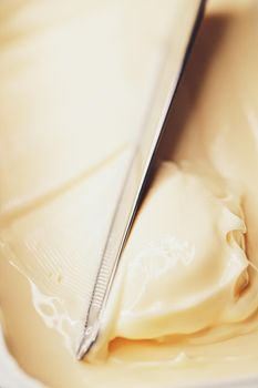 Soft spread butter and knife, breakfast food closeup