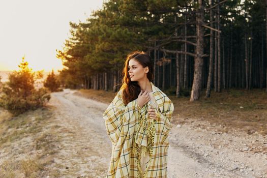 Woman health outdoors near coniferous forest at sunset. High quality photo