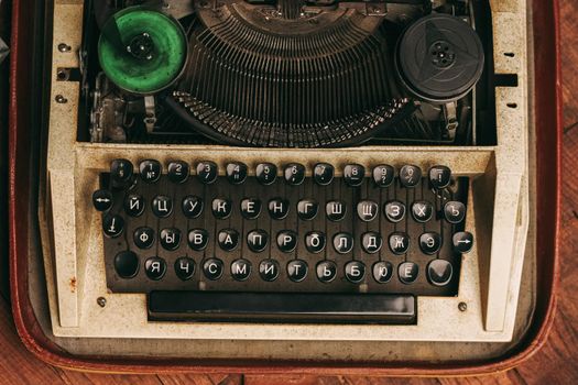 typewriter with keys letters paper wood background texture. High quality photo