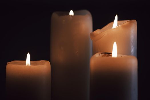 Burning candles in the dark on holiday, closeup