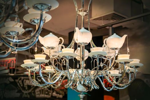 Luxurious large chandelier, lamps in the form of porcelain teapots and cups and saucers. Iron base.
