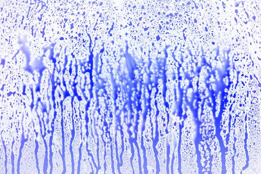 Blue dropping splatter on white surface