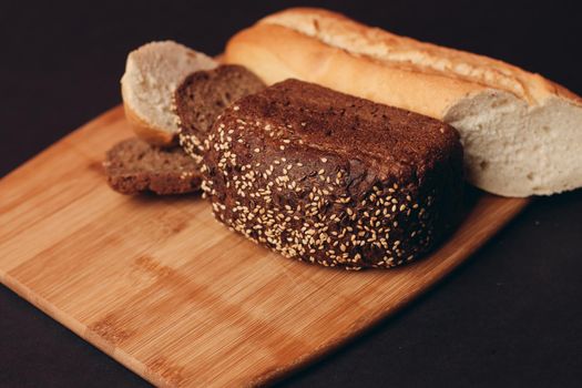 flour products loaf of bread baguette and pastries on wooden board. High quality photo