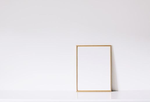 Golden vertical frame on white furniture, luxury home decor and design for mockup creations