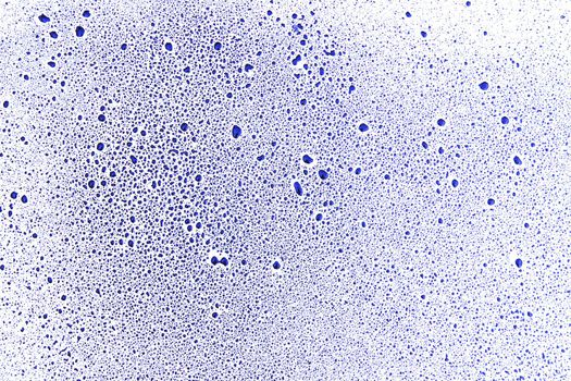 Abstract blue drops and blobs on a white surface