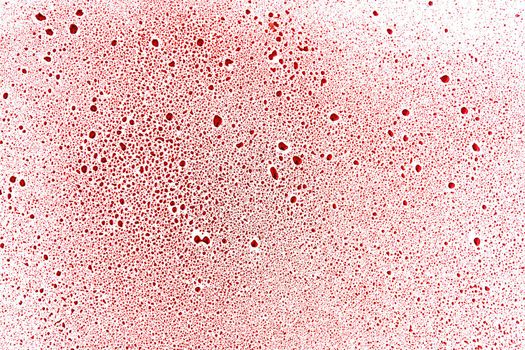 Abstract red drops and blobs on a white surface