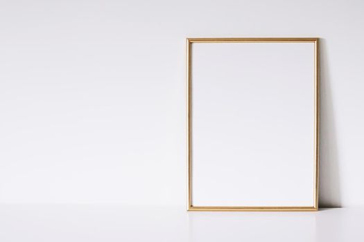 Golden vertical frame on white furniture, luxury home decor and design for mockup creations