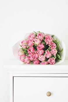 Bouquet of fresh cut pink tulips in an elegant interior, home decor closeup