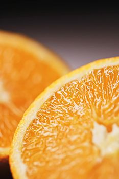 Juicy oranges half cut and sliced, healthy food and fruit closeup