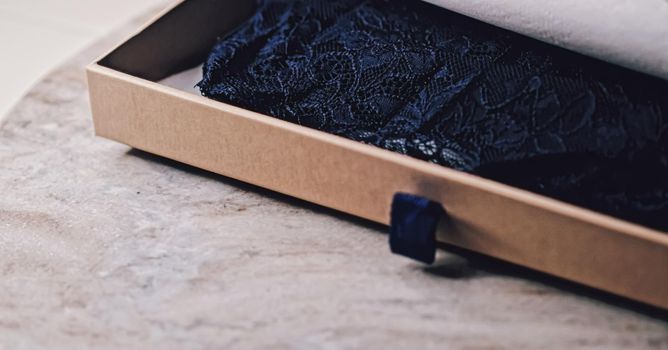 Lace garment inside elegant gift box as luxury purchase, closeup