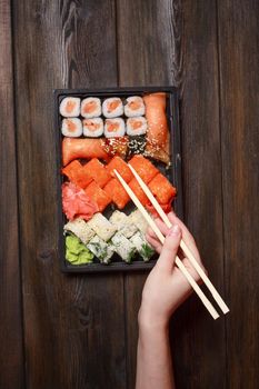 asian food delicacy sushi and rolls wooden chopsticks on table. High quality photo