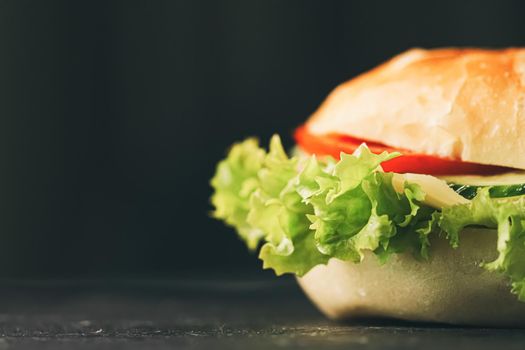 Sandwich with ham, cheese, veggies and lettuce, fast food closeup