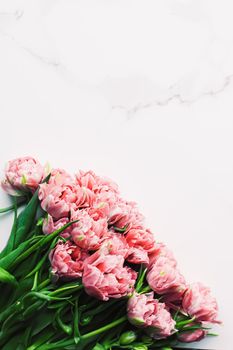 Spring flowers on marble background as holiday gift and floral flatlay concept